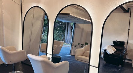 Chic interior of Salon LOTI in Newry, Northern Ireland, GB, featuring modern mirrors and stylish chairs.