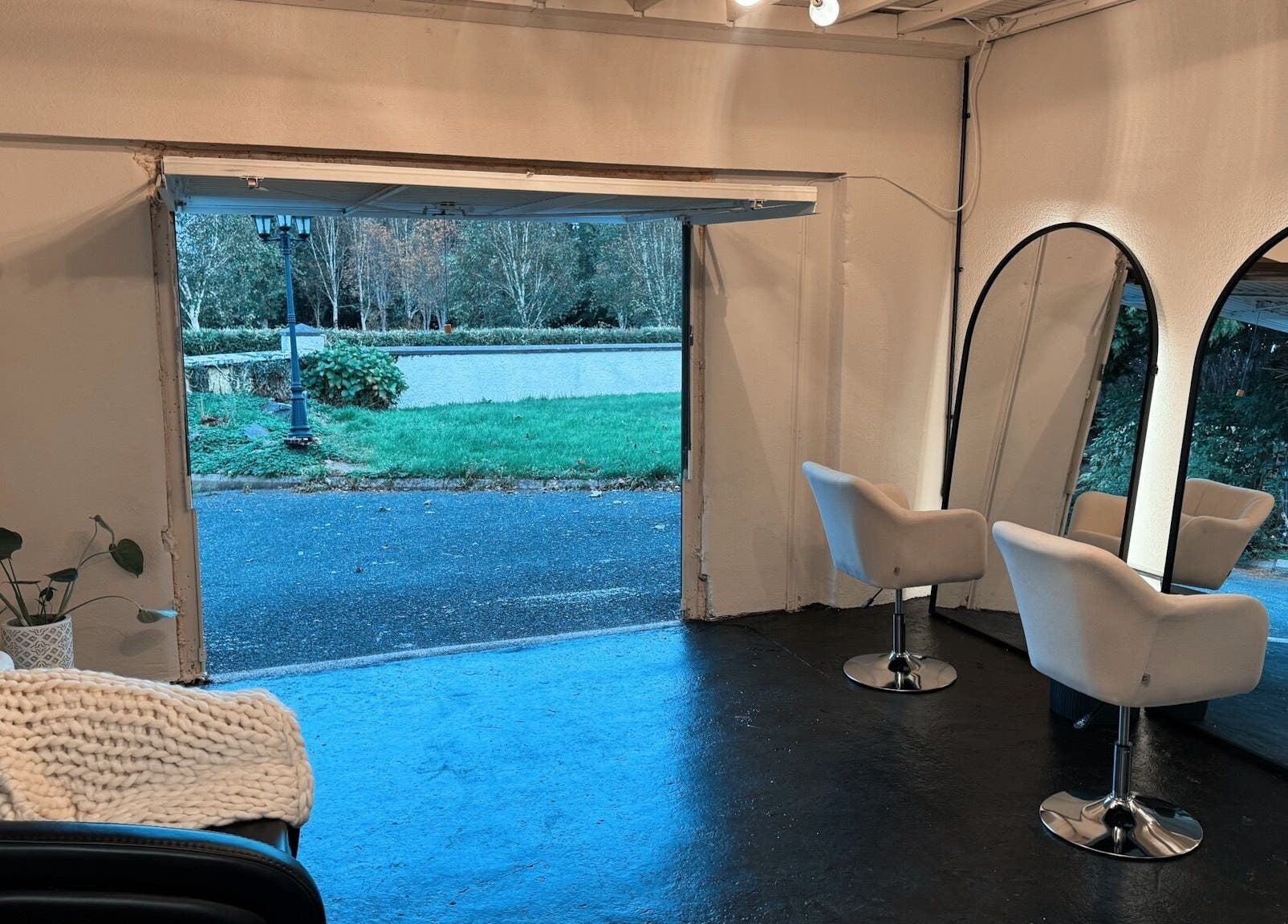 Cozy interior of Salon LOTI in Newry, Northern Ireland, GB featuring white chairs and large mirrors.