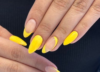 Bright yellow almond-shaped nails at Nail by Alin, Clydebank, Scotland, GB showcasing vibrant manicure.