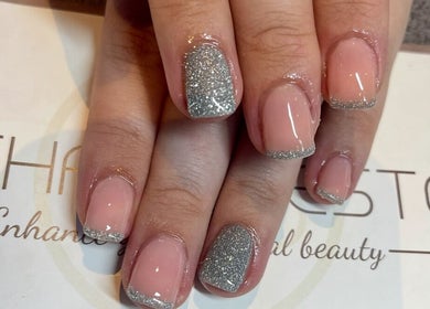 Glitter-tipped nails at Bethan Beeston, Sandbach, England, GB showcasing elegant nail art design.