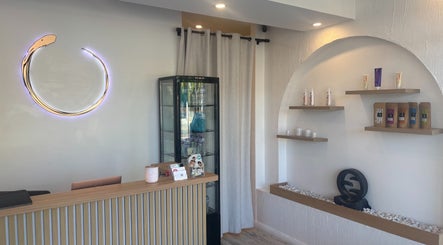 Reception area of Halo Sanctuary in Ramsgate, New South Wales, AU featuring a minimalist design and product displays.