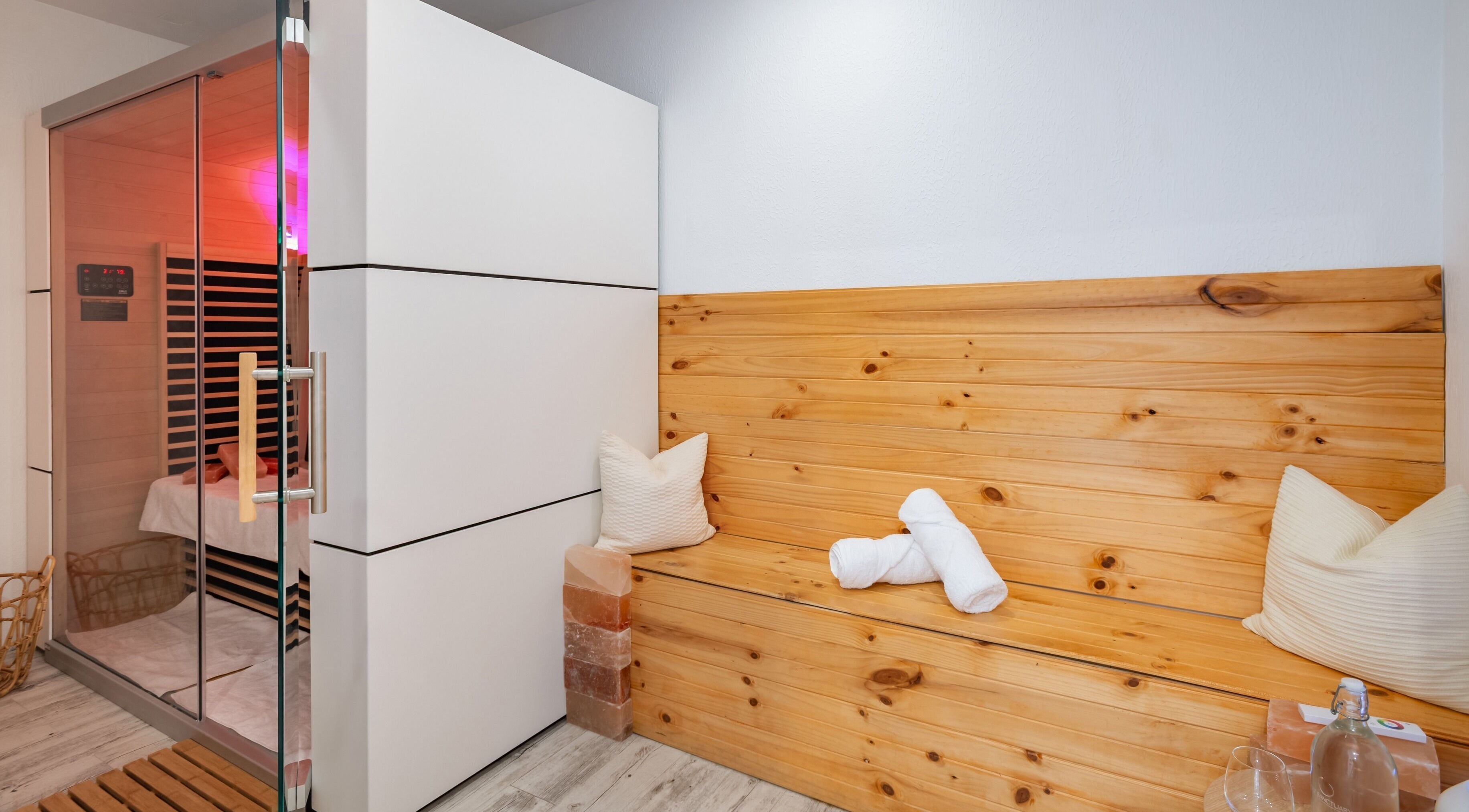 Relaxing sauna at Halo Sanctuary, Ramsgate, New South Wales, AU with wooden bench and soft lighting.
