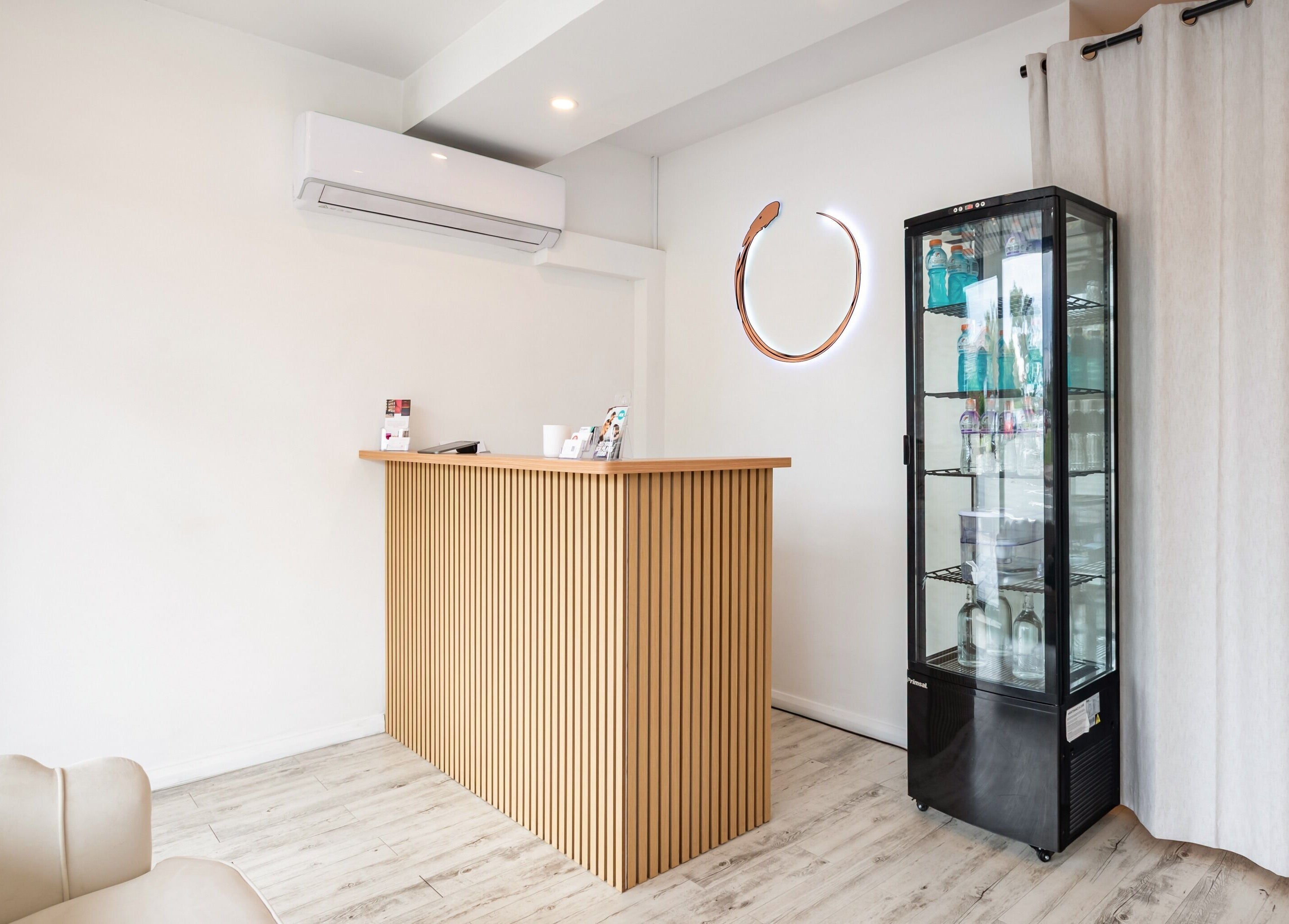 Reception area at Halo Sanctuary in Ramsgate, New South Wales, AU with modern wooden counter and minimalist decor.