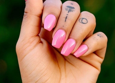Bright pink manicured nails from Nails By Tanoo, Folkestone, England, GB, showcasing vivid color and style.