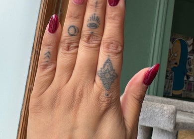 Burgundy nails with tattoos at Nails By Tanoo, Folkestone, England, GB.