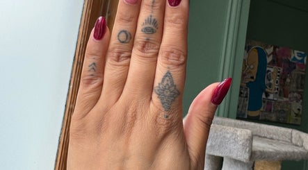 Burgundy nails with tattoos at Nails By Tanoo, Folkestone, England, GB.