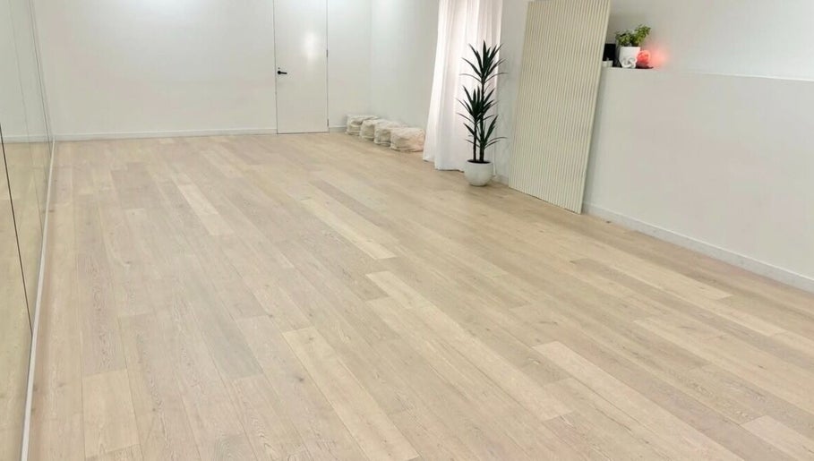 Spacious yoga studio at Fia Yoga & Pilates in Melbourne, Victoria, AU, featuring wooden floors and plants.