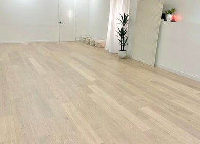 Spacious yoga studio at Fia Yoga & Pilates in Melbourne, Victoria, AU, featuring wooden floors and plants.