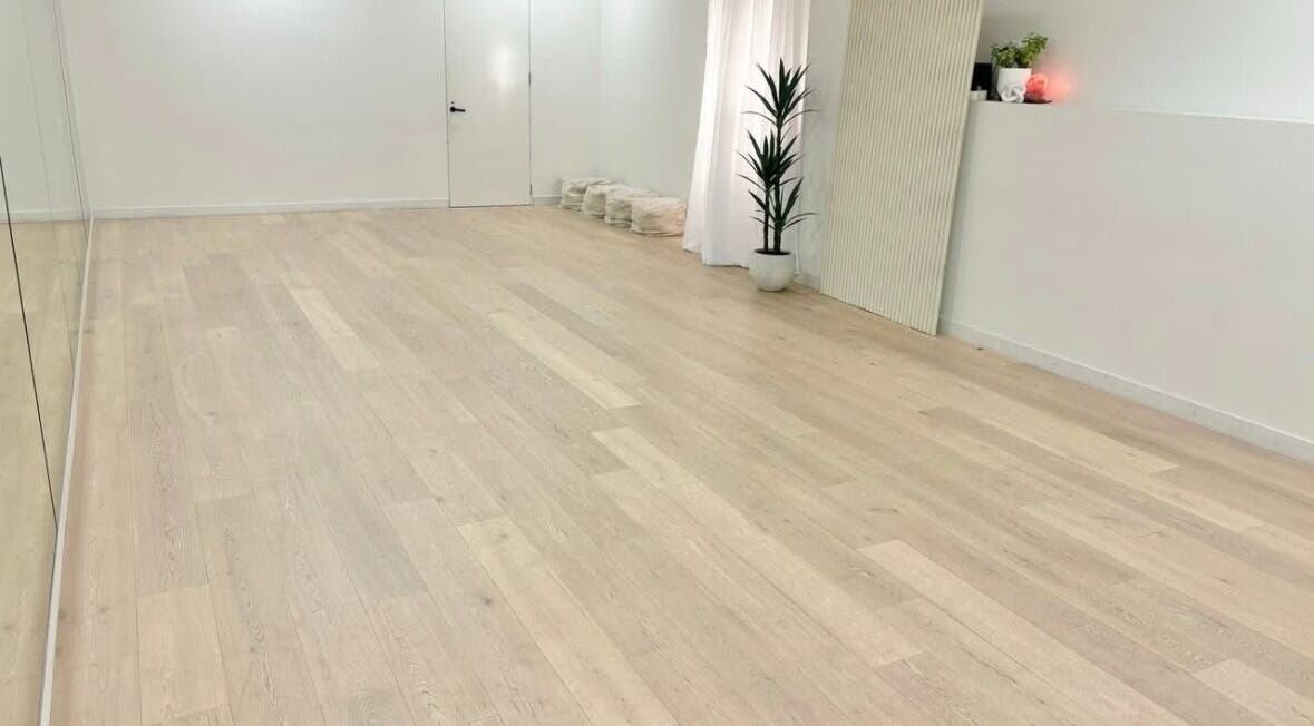 Spacious yoga studio at Fia Yoga & Pilates in Melbourne, Victoria, AU, featuring wooden floors and plants.
