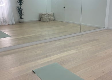 Spacious Fia Yoga & Pilates studio with mirrors and yoga mat in Melbourne, Victoria, AU.