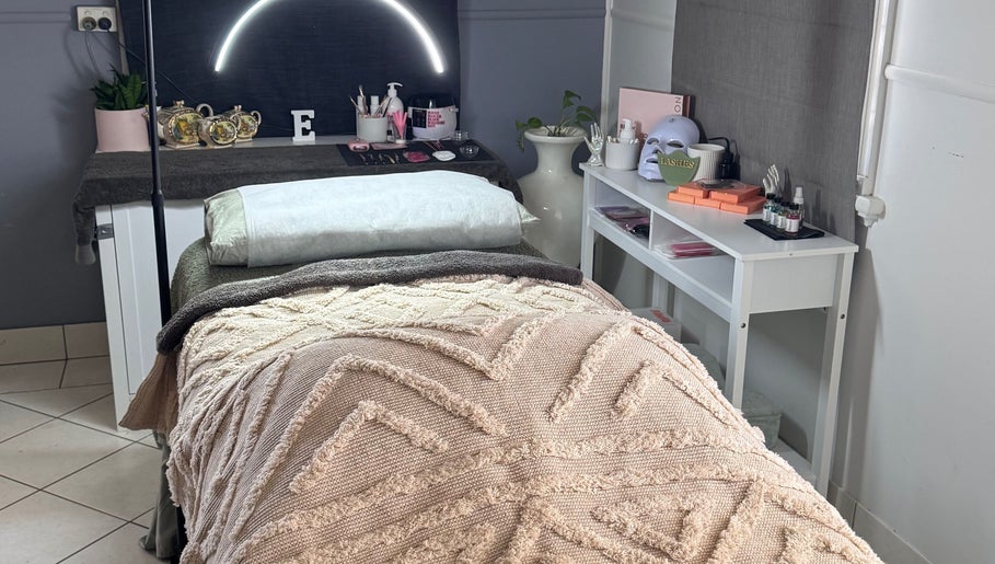 Relaxing treatment bed at Estelle Beauty - On The Range, Queensland, AU with elegant decor and soft lighting.