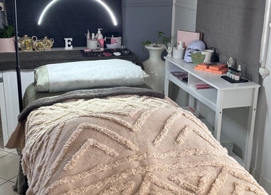 Relaxing treatment bed at Estelle Beauty - On The Range, Queensland, AU with elegant decor and soft lighting.