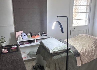 A cozy treatment room at Estelle Beauty - On The Range in Queensland, AU with a comfortable massage table.