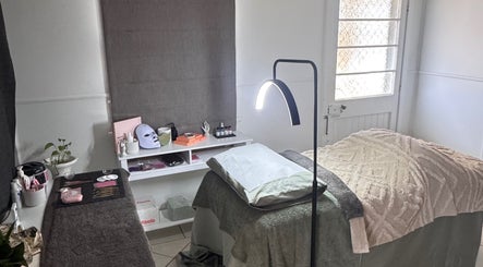 A cozy treatment room at Estelle Beauty - On The Range in Queensland, AU with a comfortable massage table.