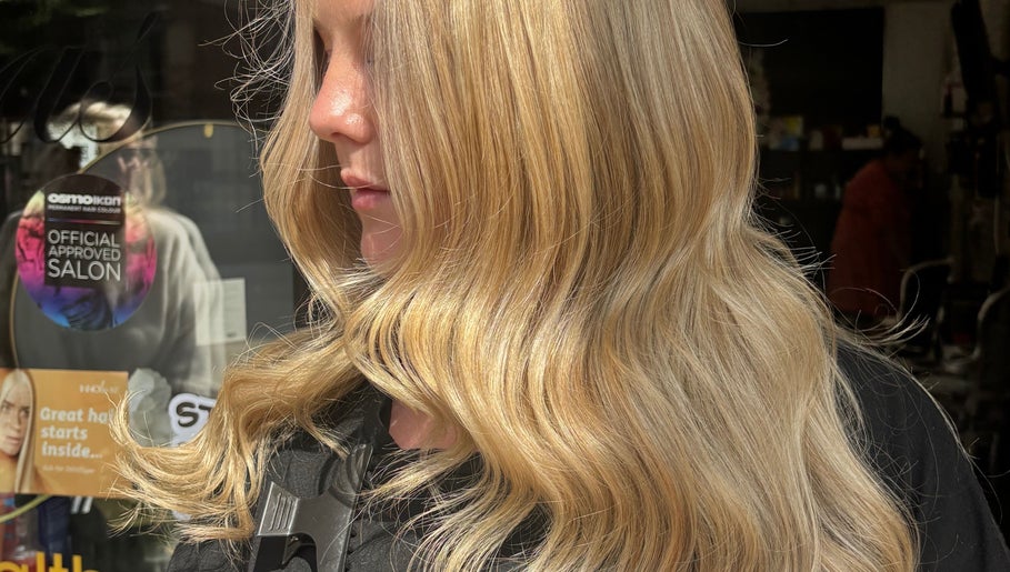 Blonde hair styled in soft waves at Ericarichardsonhair, Hornchurch, England, GB.