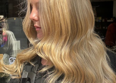 Blonde hair styled in soft waves at Ericarichardsonhair, Hornchurch, England, GB.