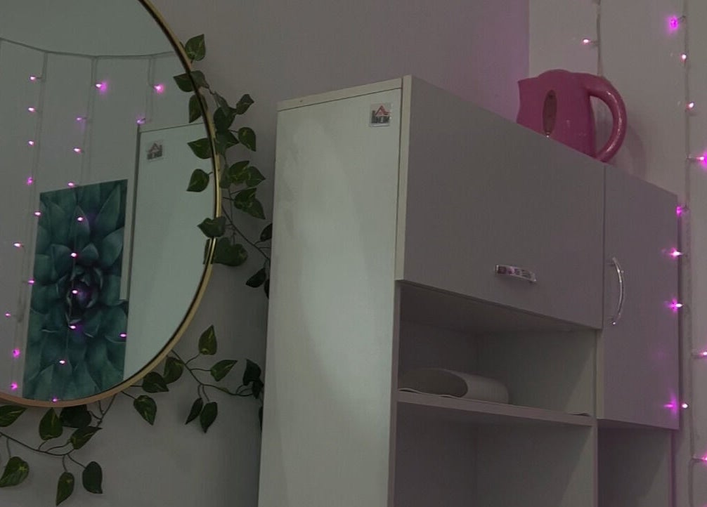 Cozy corner with pink lights at NailsBy.aa, Hamilton, Ontario, CA, creating a relaxing ambiance.