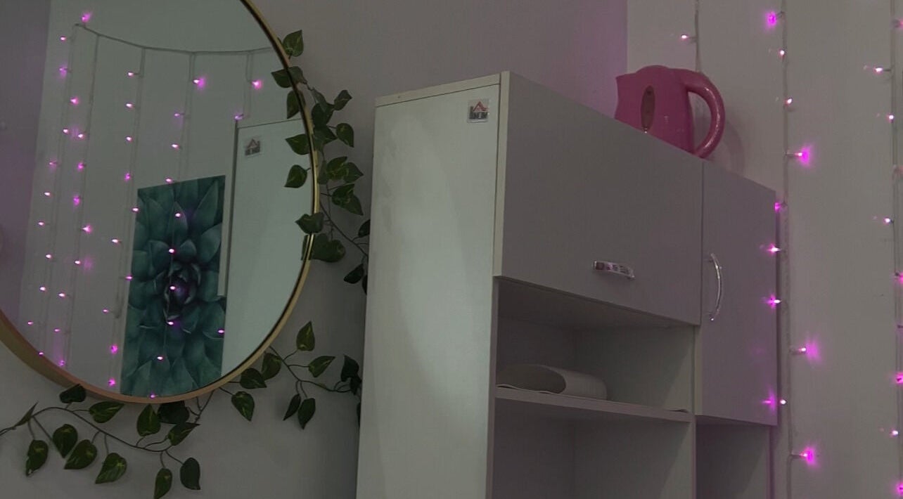 Cozy corner with pink lights at NailsBy.aa, Hamilton, Ontario, CA, creating a relaxing ambiance.