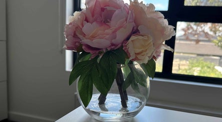 Elegant pink and cream blossoms in a glass vase at Eating Disorders Melbourne, Melbourne, Victoria, AU.