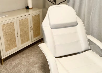 Cozy treatment room at Aesthetinks Wellness Studio, Riverview, Florida, US, featuring a plush white chair.