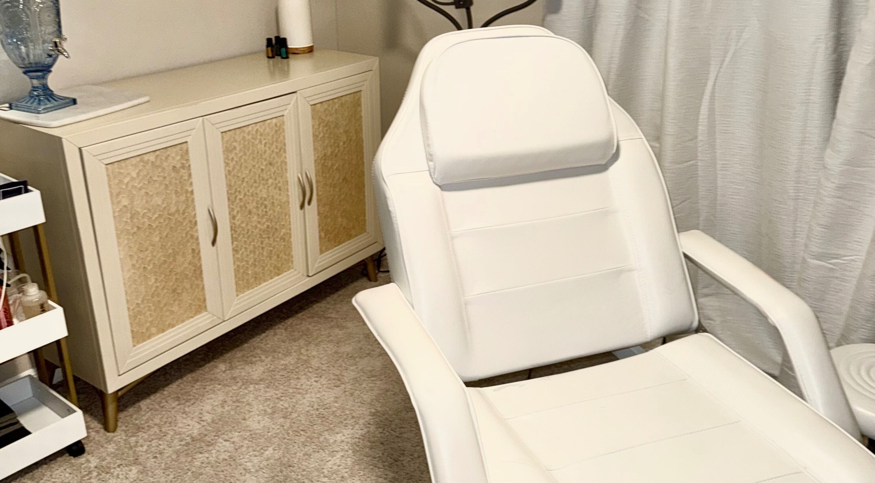 Cozy treatment room at Aesthetinks Wellness Studio, Riverview, Florida, US, featuring a plush white chair.