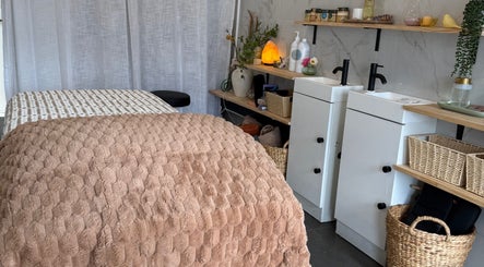 Cozy spa room with massage bed at Nothin Knotty, Kogarah, New South Wales, AU. Calm ambiance for relaxation.