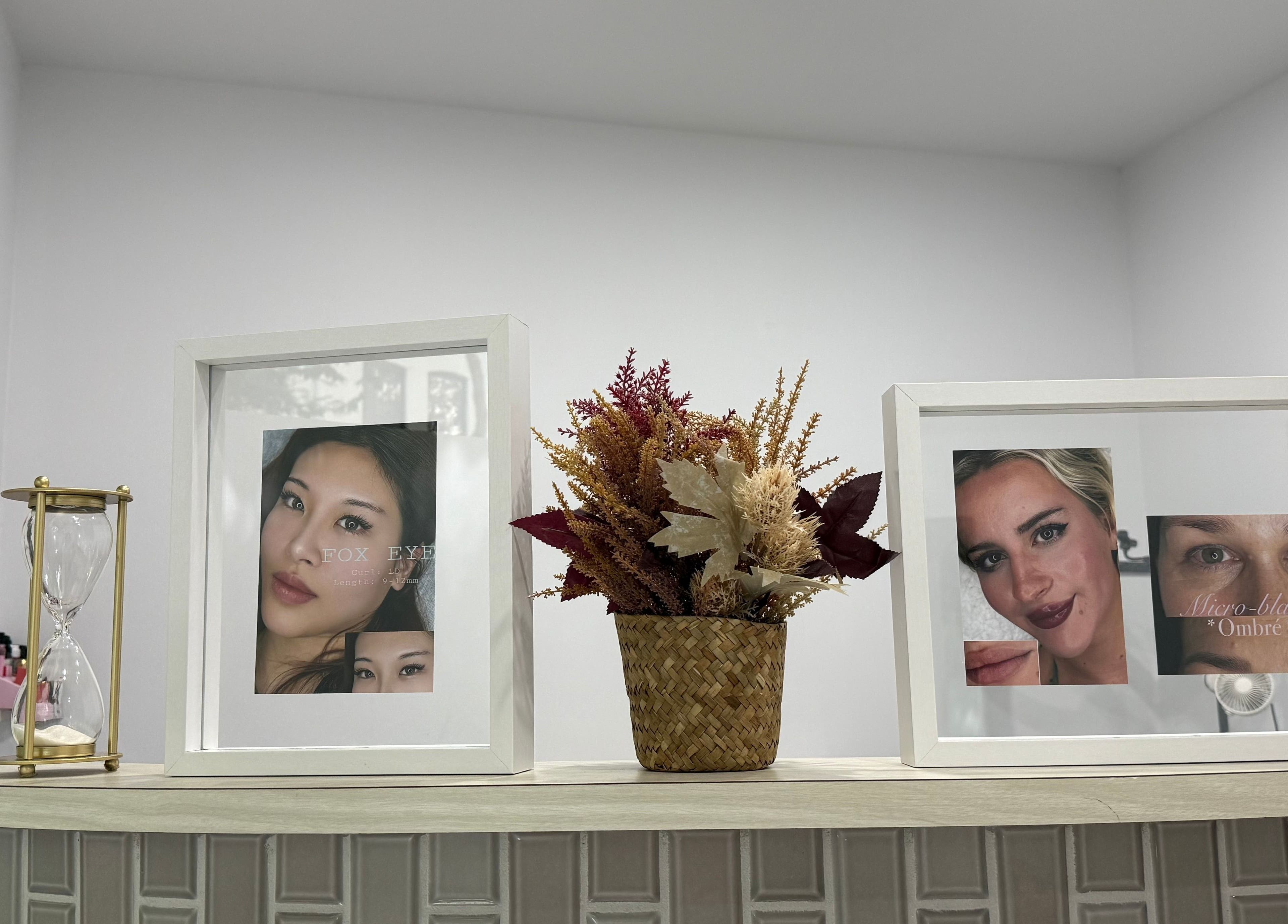 Decorative shelf with framed photos at Lumi Lash & Brow, Ultimo, New South Wales, AU.