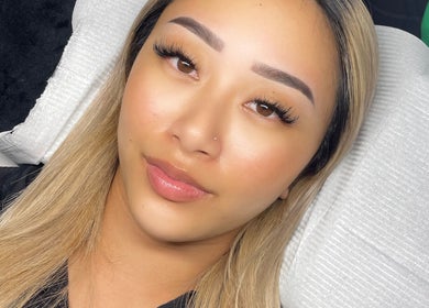 Client with flawless skin and defined lashes at SKULPTED, Fairfield, New South Wales, AU.