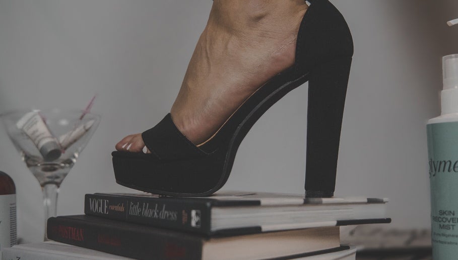Elegant high heel on books at Skinxlex Esthetics, Hallsville, Texas, US, showcasing modern beauty style.