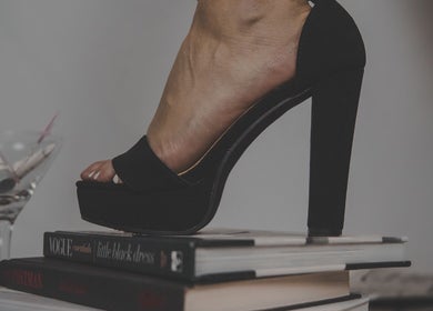 Elegant high heel on books at Skinxlex Esthetics, Hallsville, Texas, US, showcasing modern beauty style.