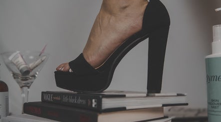 Elegant high heel on books at Skinxlex Esthetics, Hallsville, Texas, US, showcasing modern beauty style.