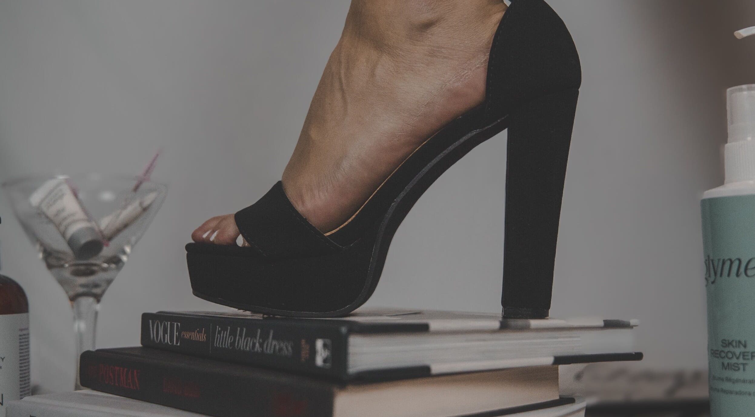 Elegant high heel on books at Skinxlex Esthetics, Hallsville, Texas, US, showcasing modern beauty style.