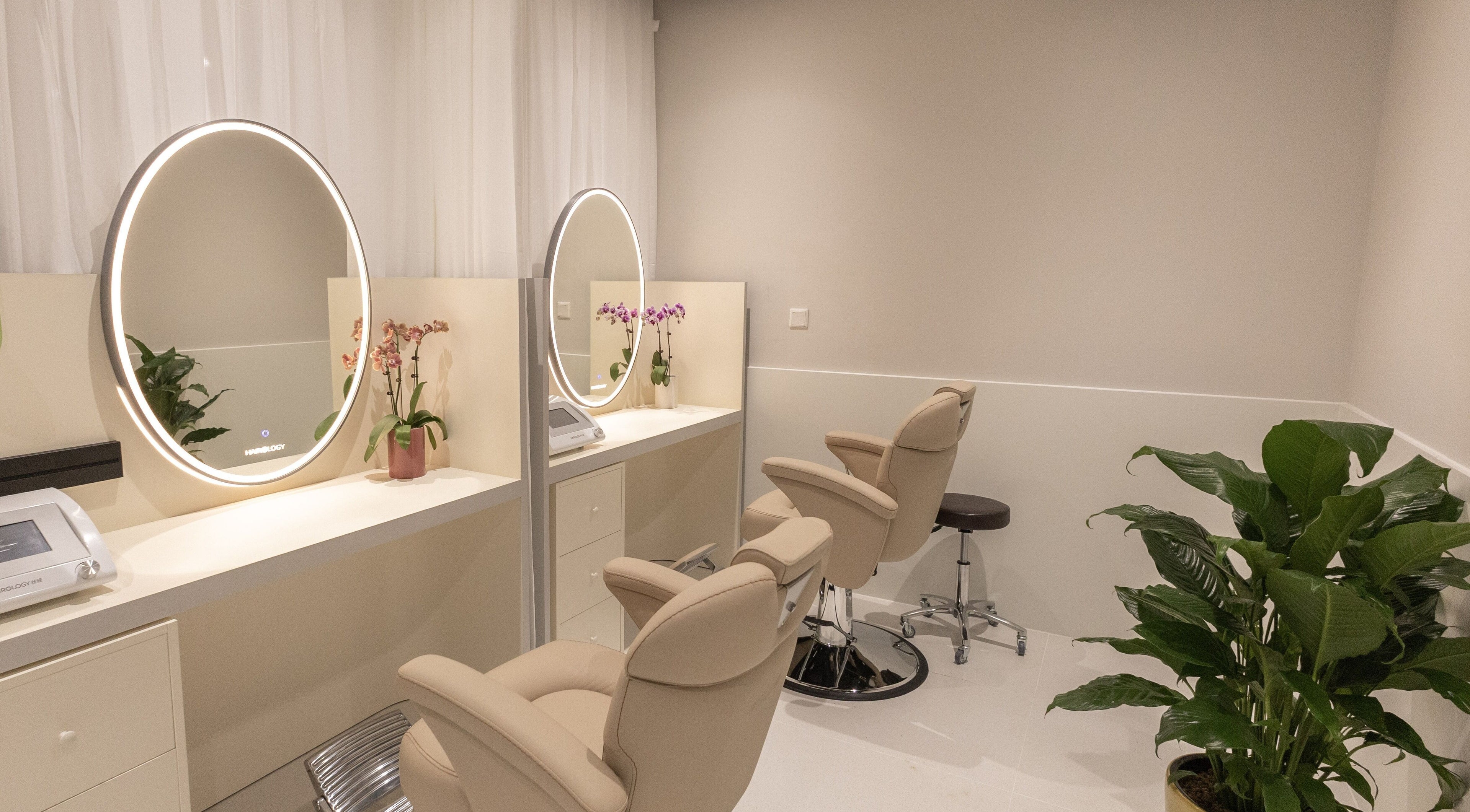 Sleek salon chairs with mirrors at HAIROLOGY丝域养发, Singapore, Singapore, SG; perfect blend of style and comfort.