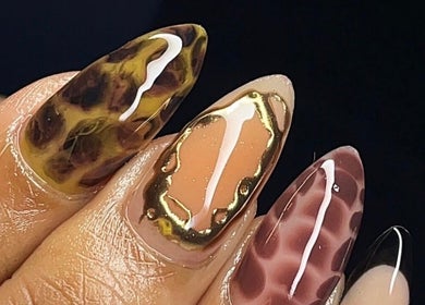 Close-up of intricate nail art at Sets By Talia, Cape Town, Western Cape, ZA showcasing leopard and gold designs.