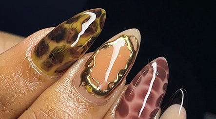 Close-up of intricate nail art at Sets By Talia, Cape Town, Western Cape, ZA showcasing leopard and gold designs.