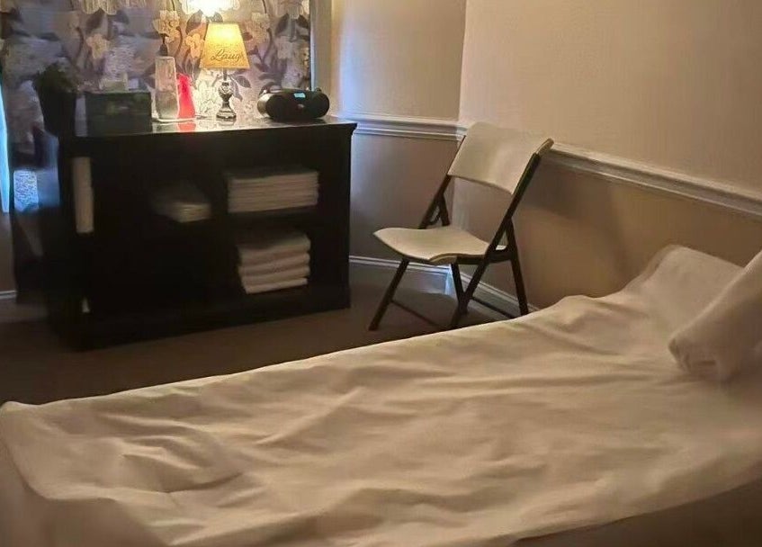 Cozy spa room at Acupressure Spa, Burke, Virginia, US with massage bed and soft lighting.