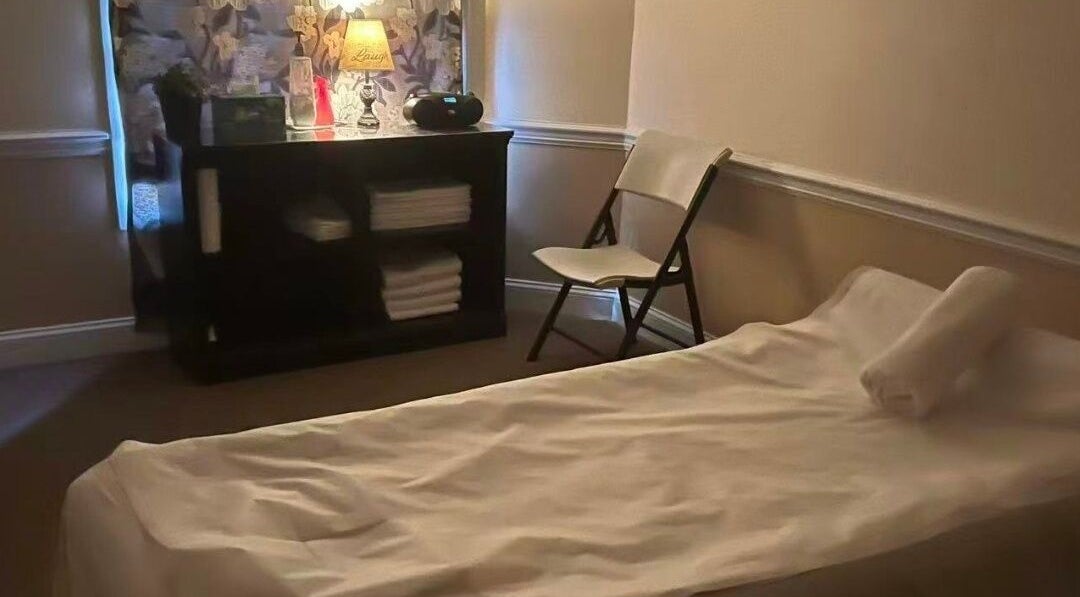 Cozy spa room at Acupressure Spa, Burke, Virginia, US with massage bed and soft lighting.