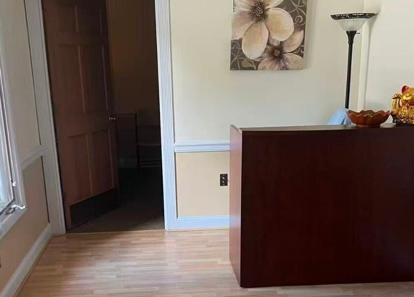 Reception area at Acupressure Spa in Burke, Virginia, US featuring decor and a lucky cat statue.