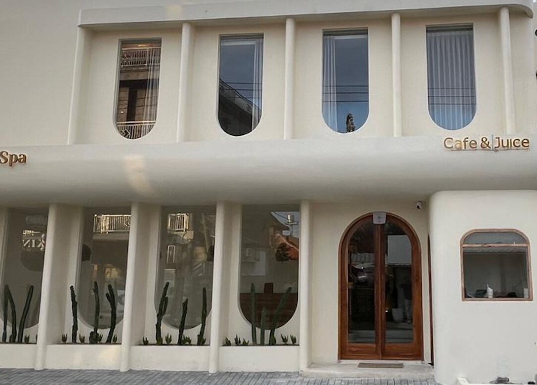 Elegant facade of Alma Spa Bali Canggu, located in Bali, Bali, ID, with modern design and cafe signage.