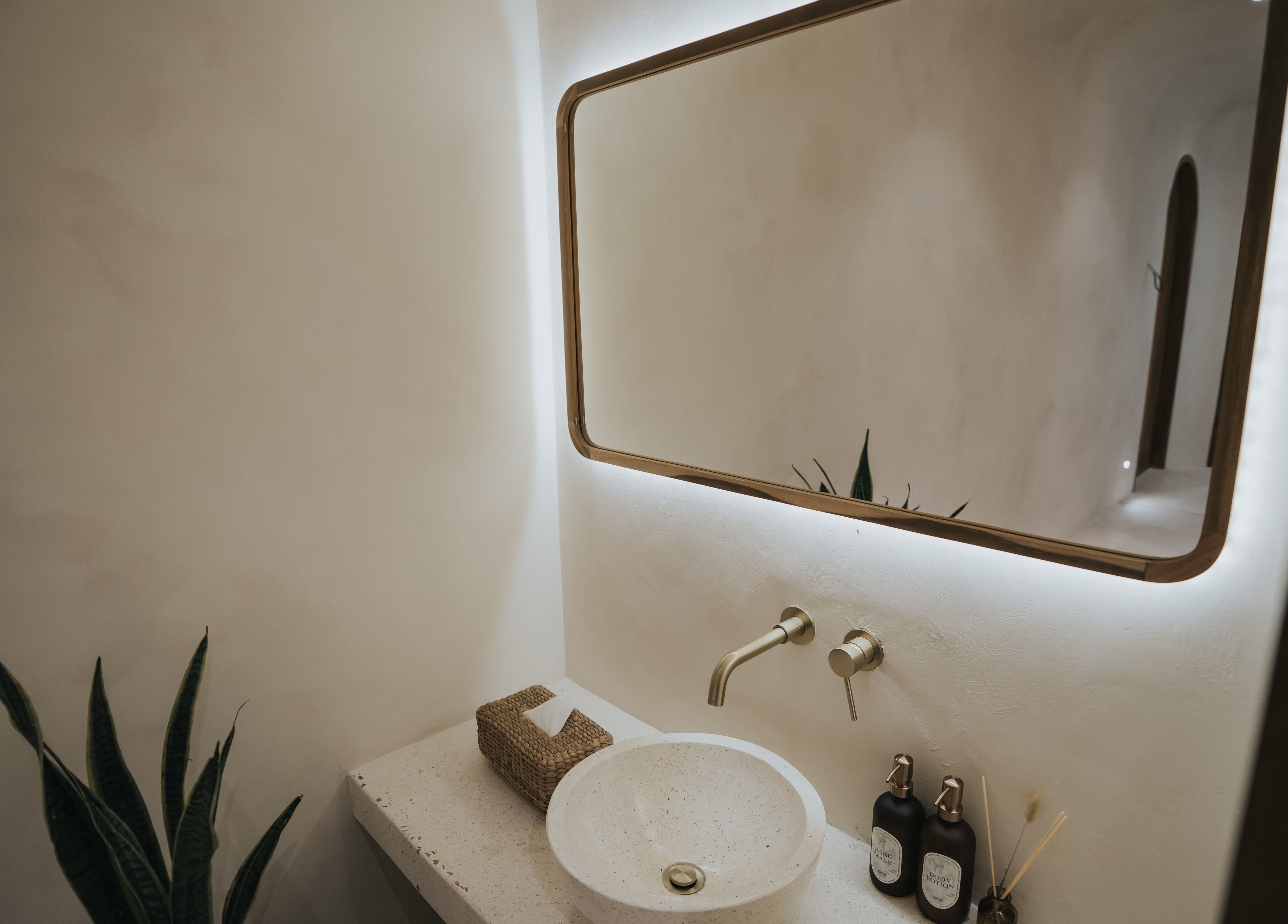 Elegant bathroom at Alma Spa Bali Canggu featuring a minimalist sink and mirror, located in Bali, Bali, ID.