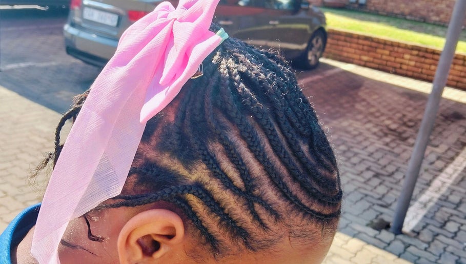 Intricate braids with a pink ribbon at 365days mobile hair & beauty, Kempton Park, Gauteng, ZA.