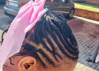 Intricate braids with a pink ribbon at 365days mobile hair & beauty, Kempton Park, Gauteng, ZA.