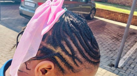 Intricate braids with a pink ribbon at 365days mobile hair & beauty, Kempton Park, Gauteng, ZA.