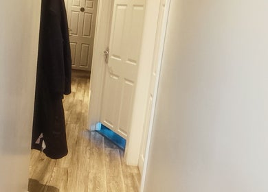 Bright hallway at Physical Therapy in Greenford, England, GB with wooden floors and white doors.