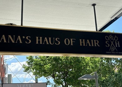 Elegant sign of Sana's Haus of Hair, Bexley North, New South Wales, AU, under a bright sky.