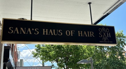 Elegant sign of Sana's Haus of Hair, Bexley North, New South Wales, AU, under a bright sky.