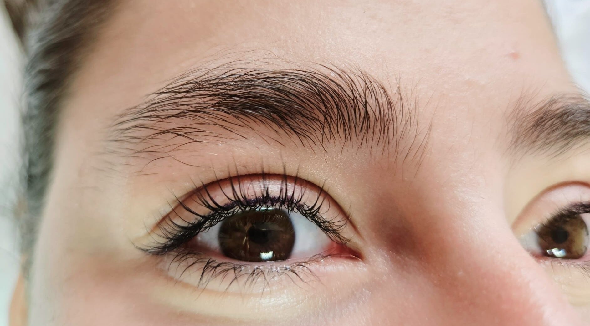 Close-up of elegantly shaped brows and lashes at Beauty Artisan, Norwich, England, GB.