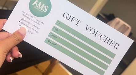 AMS Sports Therapy gift voucher in hand, Wishaw, Scotland, GB.