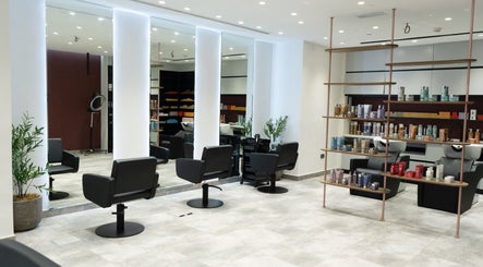 Modern salon at MIER BEAUTY LOUNGE in Abu Dhabi, AE with sleek chairs and product shelves.