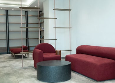 Modern lounge area with red seating at MIER BEAUTY LOUNGE, Abu Dhabi, Abu Dhabi, AE.